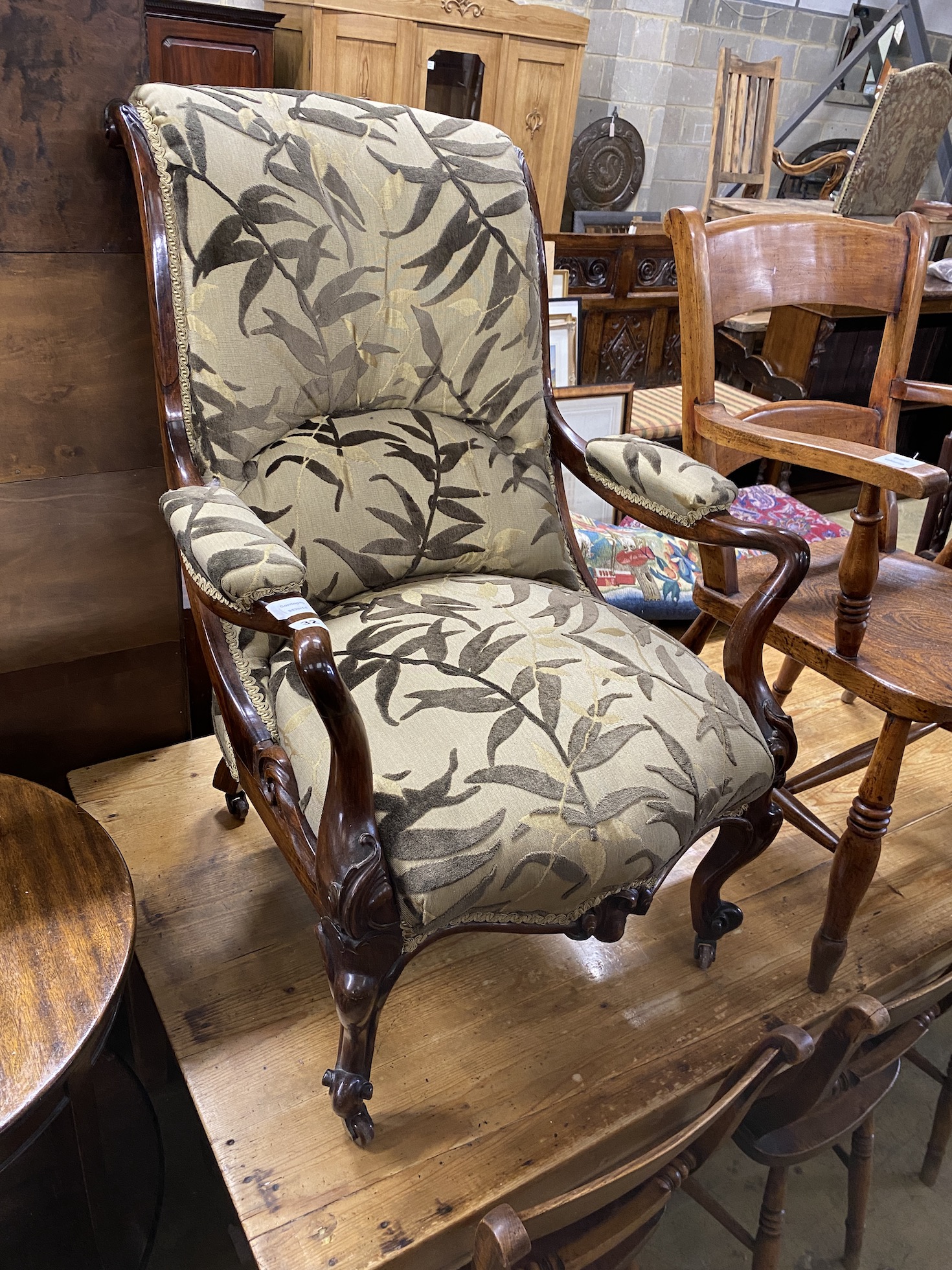 A Victorian rosewood upholstered open armchair, width 65cm, depth 72cm, height 95cm